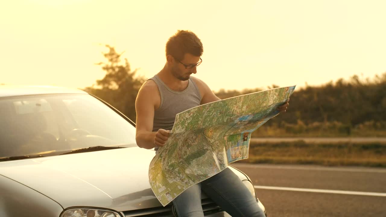 Stock Video Man Sitting In His Car Looks At A Map O Animated Wallpaper - Free Download