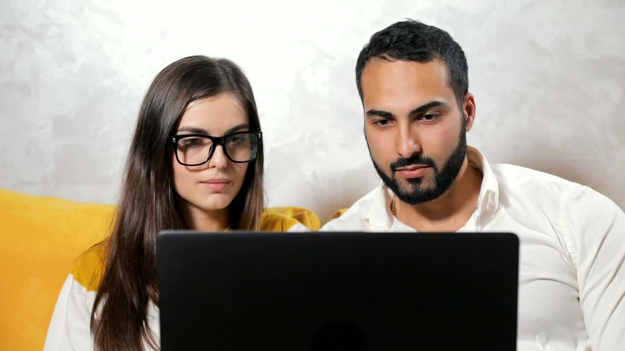 Stock Video Couple Surprised By What They See On Their Laptop Live Wallpaper For PC - Free Download