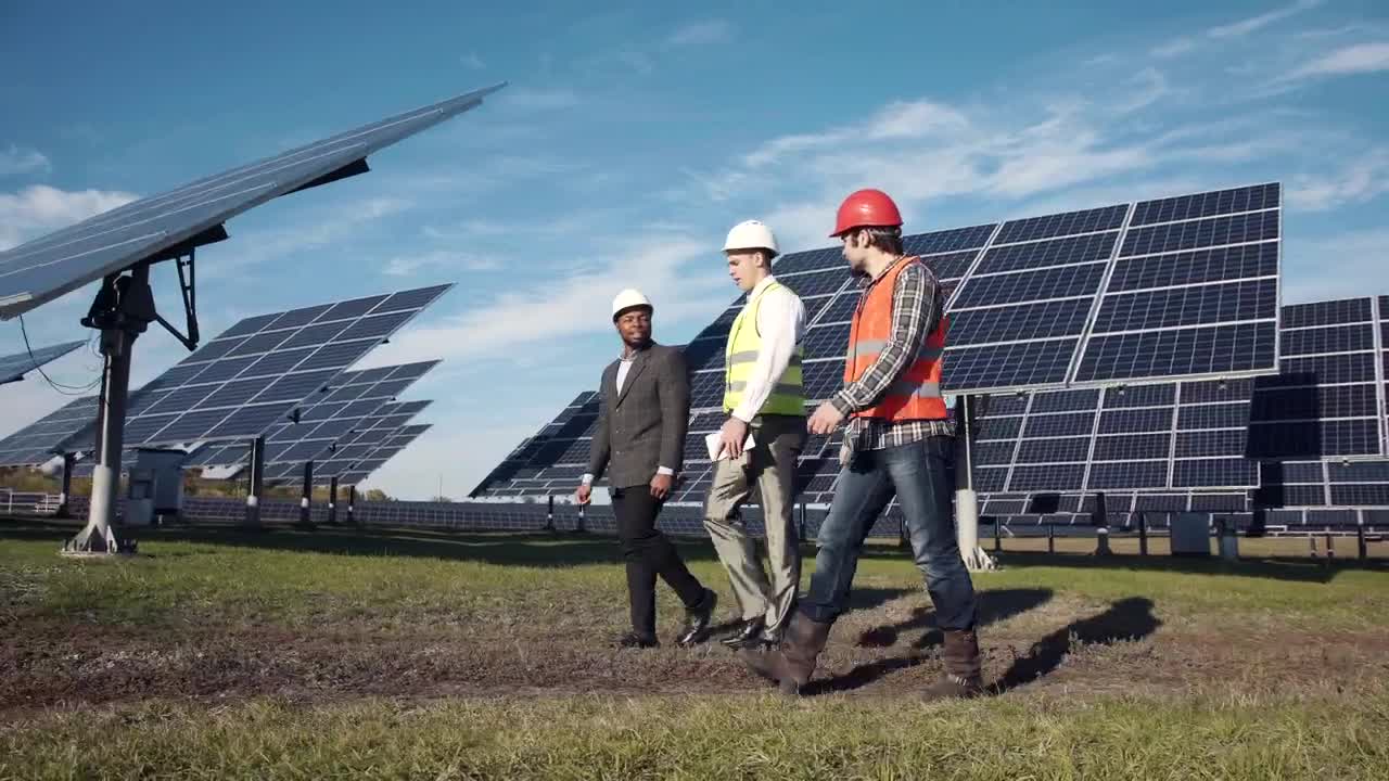 Free Video Stock three engineers working on a solar panel field Live Wallpaper - Free Download