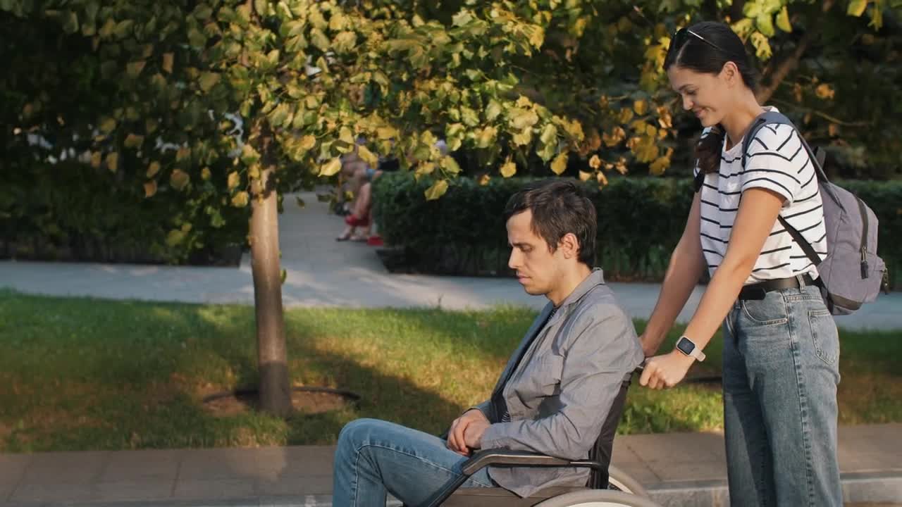 Free Stock Video Woman Helps Man In Wheelchair On The Street Live Wallpaper - Free Download