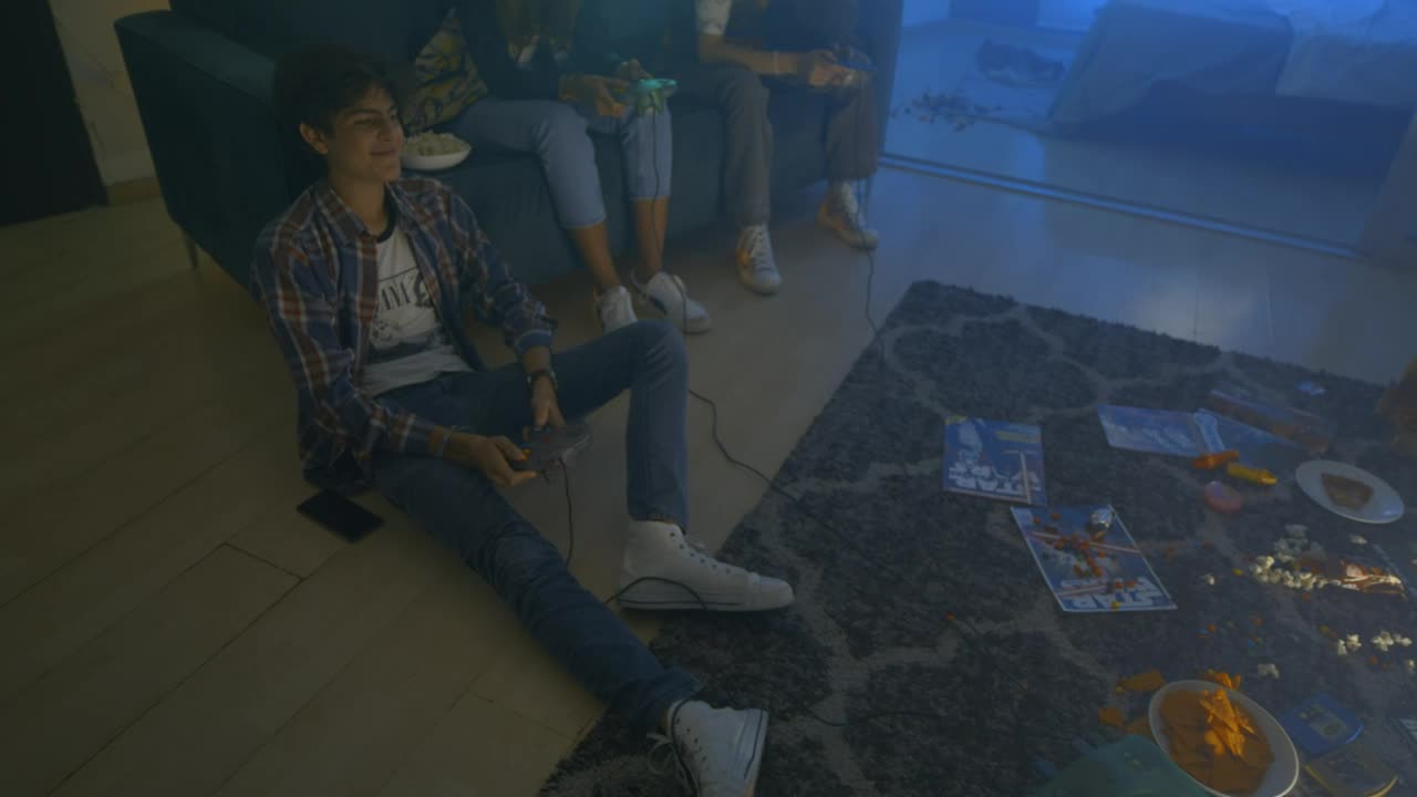 Free Video Stock three friends during a video games night Live Wallpaper - Free Download