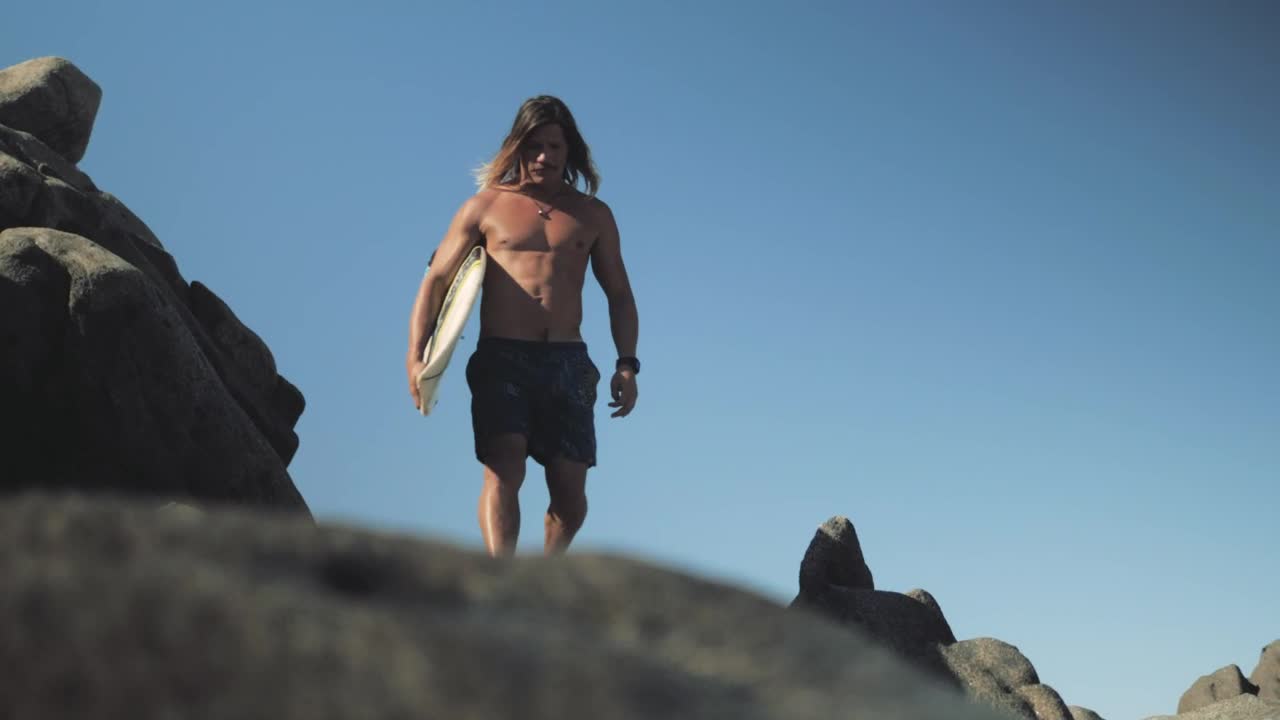 Stock Video Man With Surfboard Walks On Rocks At The Se Animated Wallpaper - Free Download