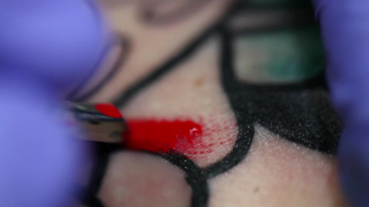 Free Video Stock tattoo artist coloring a tattoo Live Wallpaper - Free Download