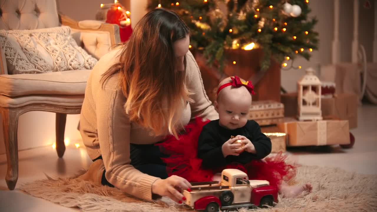 Stock Video Happy Mom With Her Baby On Christmas Night Animated Wallpaper - Free Download