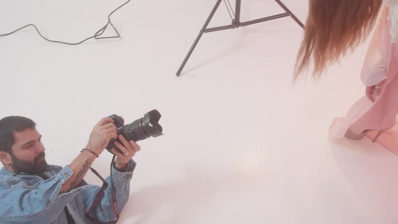 Stock Video Experienced Photographer During A Photo Shoot With A Model Live Wallpaper For PC - Free Download