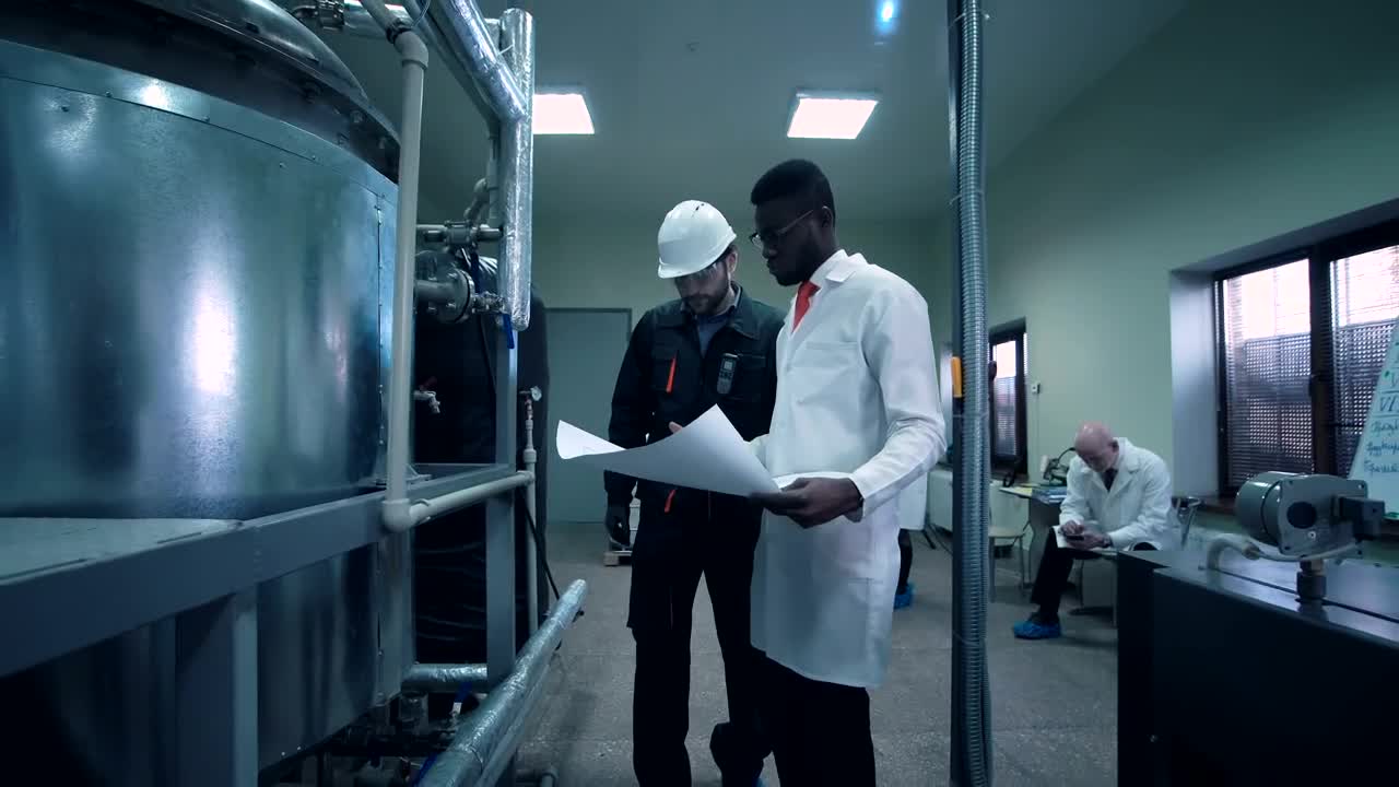 Free Stock Video Scientist Walking Through Lab With A Blueprint Live Wallpaper - Free Download