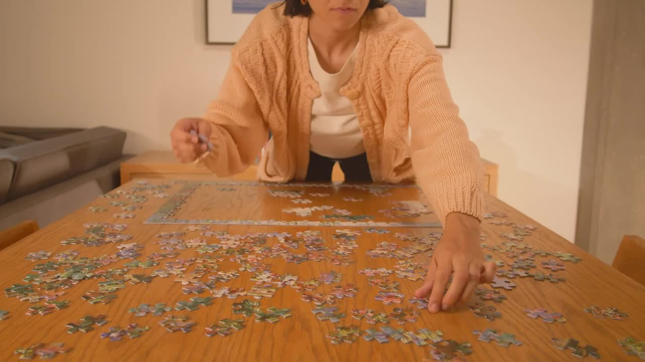 Free Stock Video Woman Putting Together A Puzzle Of Many Pieces 42195Live Wallpaper - Free Download