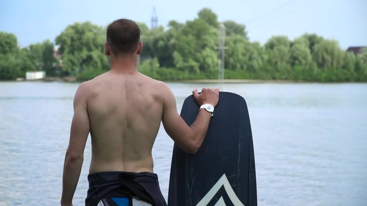 Stock Video Paddlesurfer Stands With Board Looking At Water Live Wallpaper - Free Download