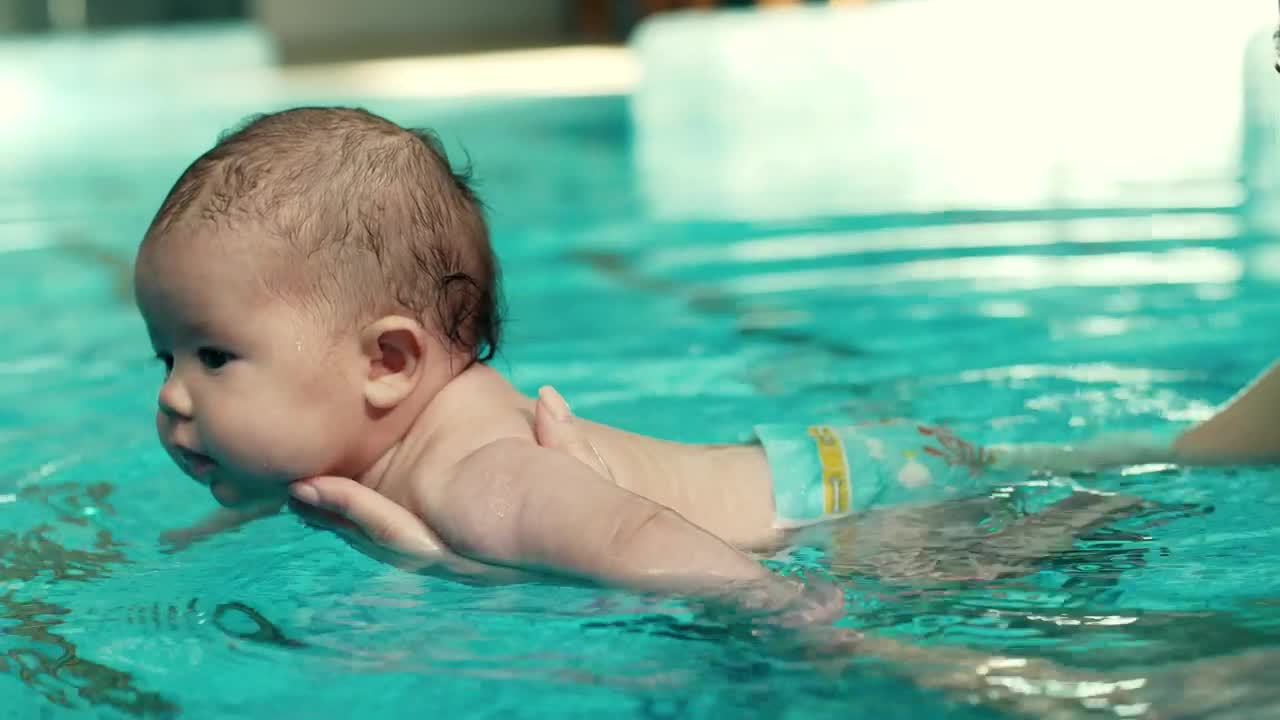 Free Video Stock teaching a baby to swim in the pool Live Wallpaper - Free Download