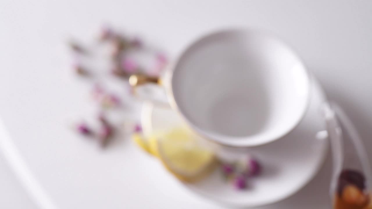 Free Video Stock top view of teapot pouring tea into china cup Live Wallpaper - Free Download