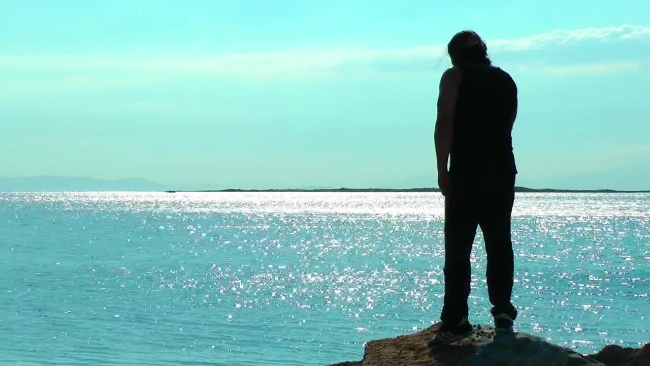 Stock Video Man Exercising On A Cliff By The Sea Animated Wallpaper - Free Download