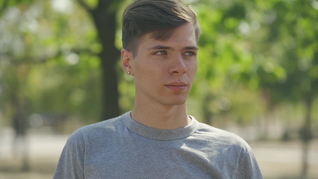 Stock Video Millennial Man Smiles At Camera In Outdoor Portrai Animated Wallpaper - Free Download