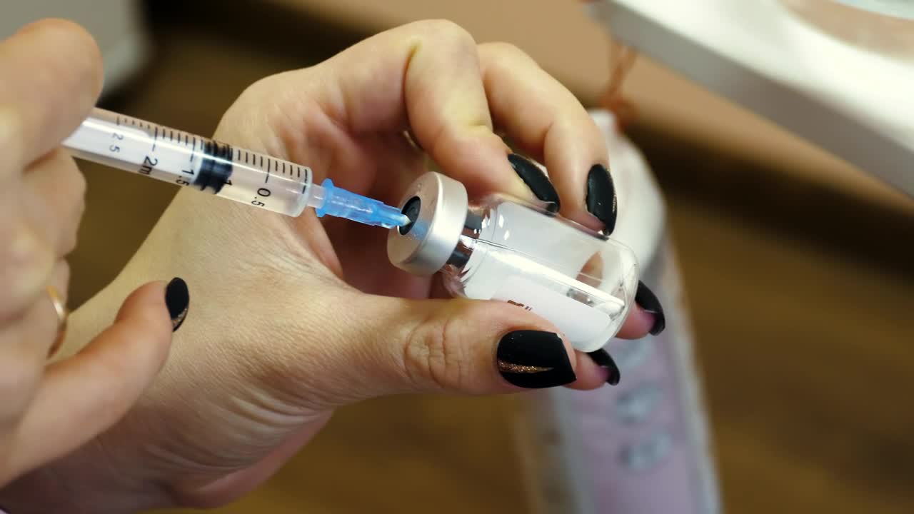 Stock Video Female Doctor Is Preparing An Injection Syringe Live Wallpaper For PC - Free Download