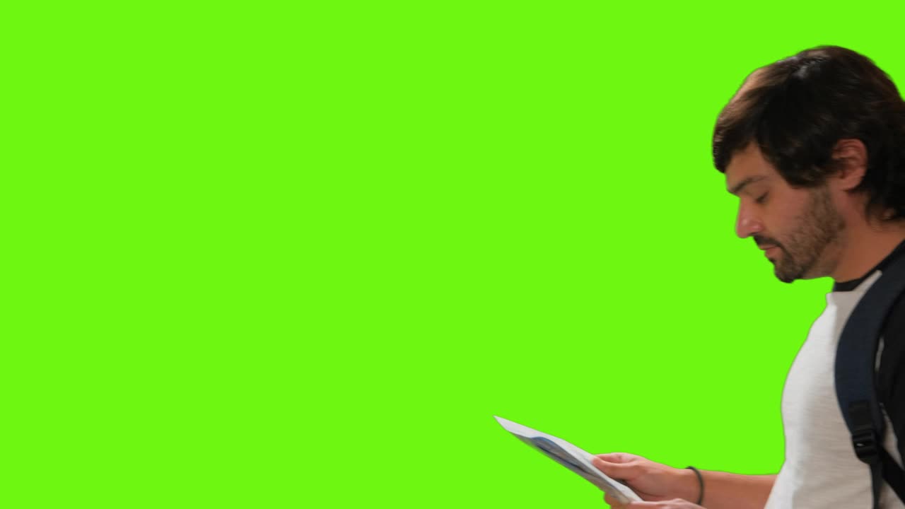 Free Video Stock tourist locating himself on a map on a chroma green Live Wallpaper - Free Download