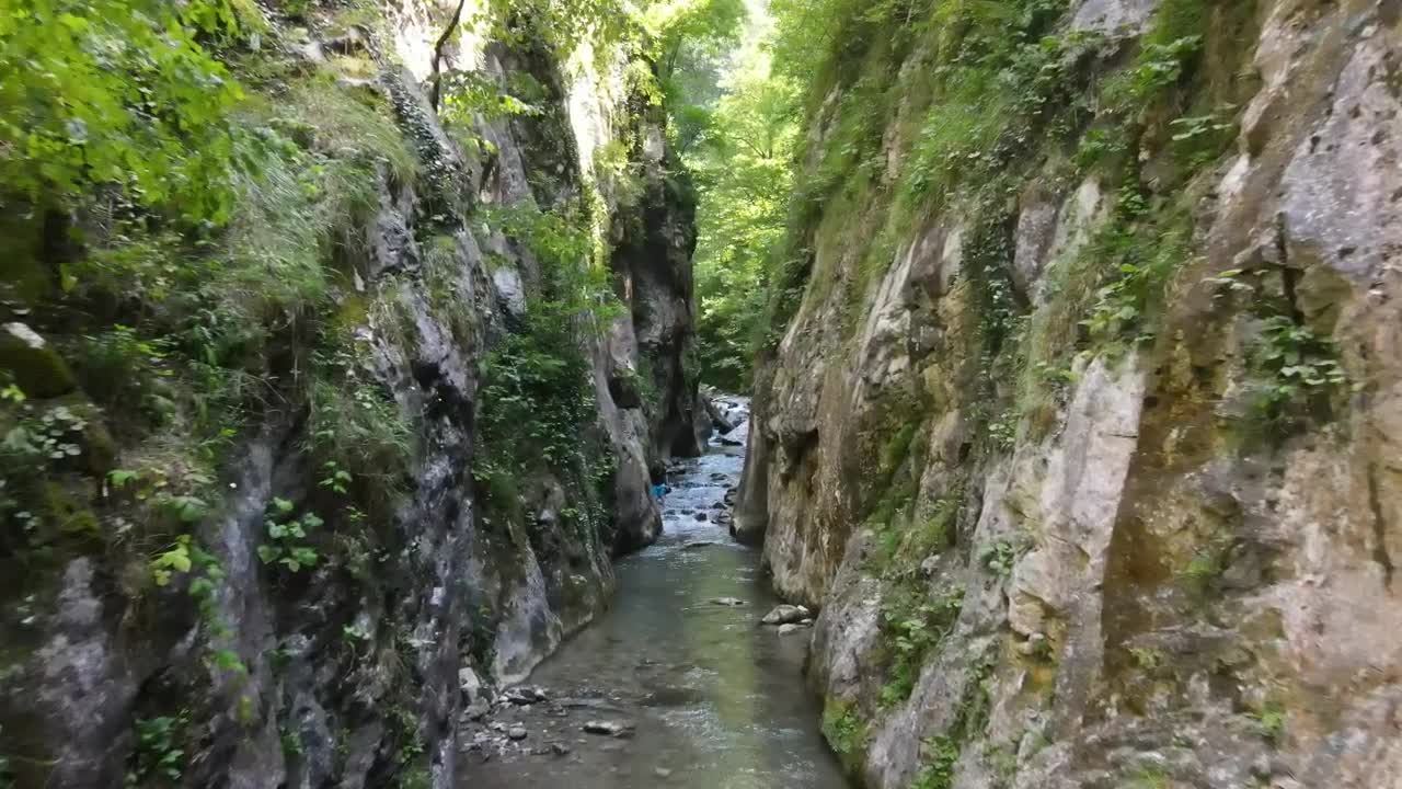 Stock Video Man Hiking In A Canyon With A Stream Animated Wallpaper - Free Download