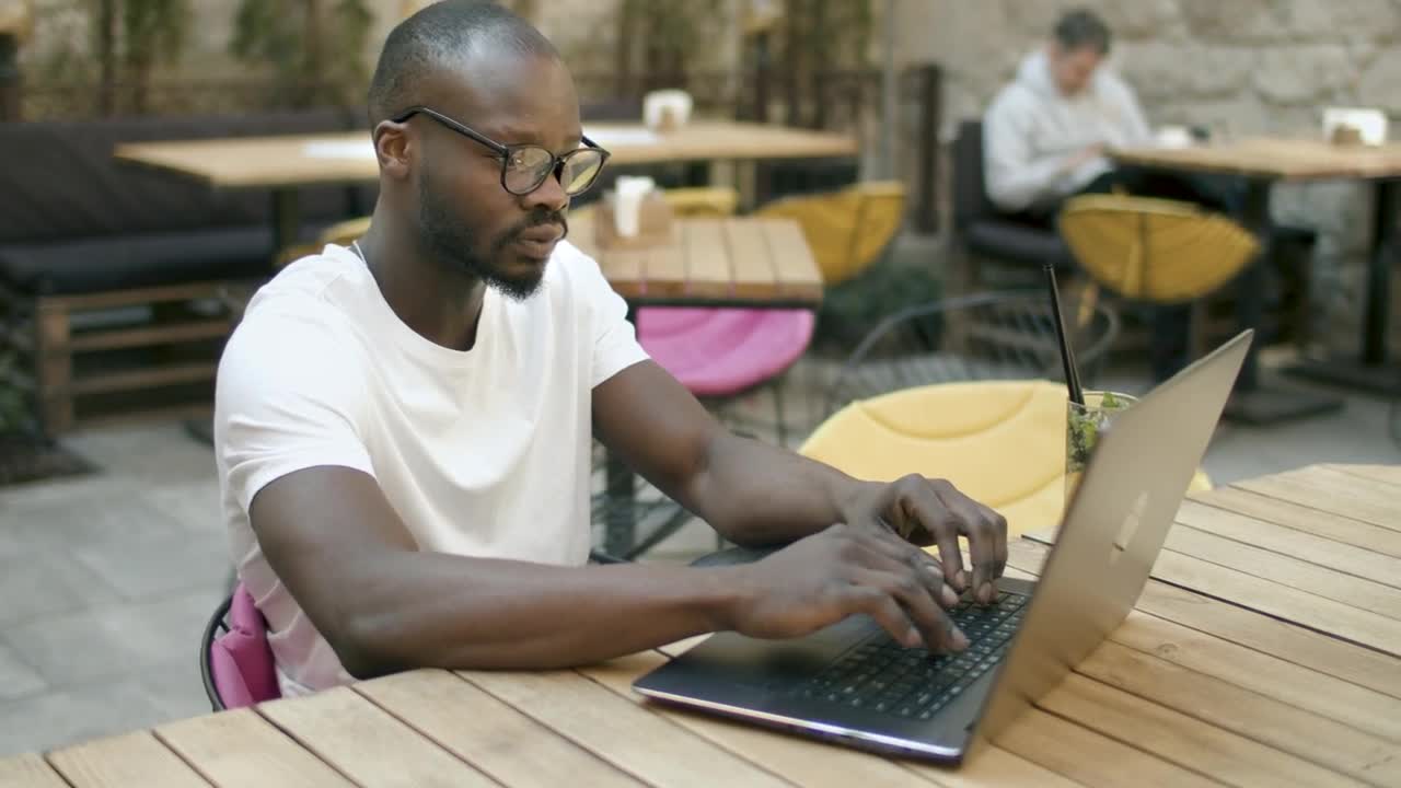 Stock Video Man Doing Online Research In Outdoor Cafe Animated Wallpaper - Free Download