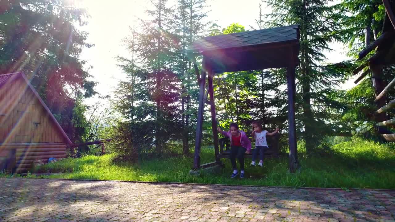 Stock Video Little Girls On A Swing In The Country House Animated Wallpaper - Free Download