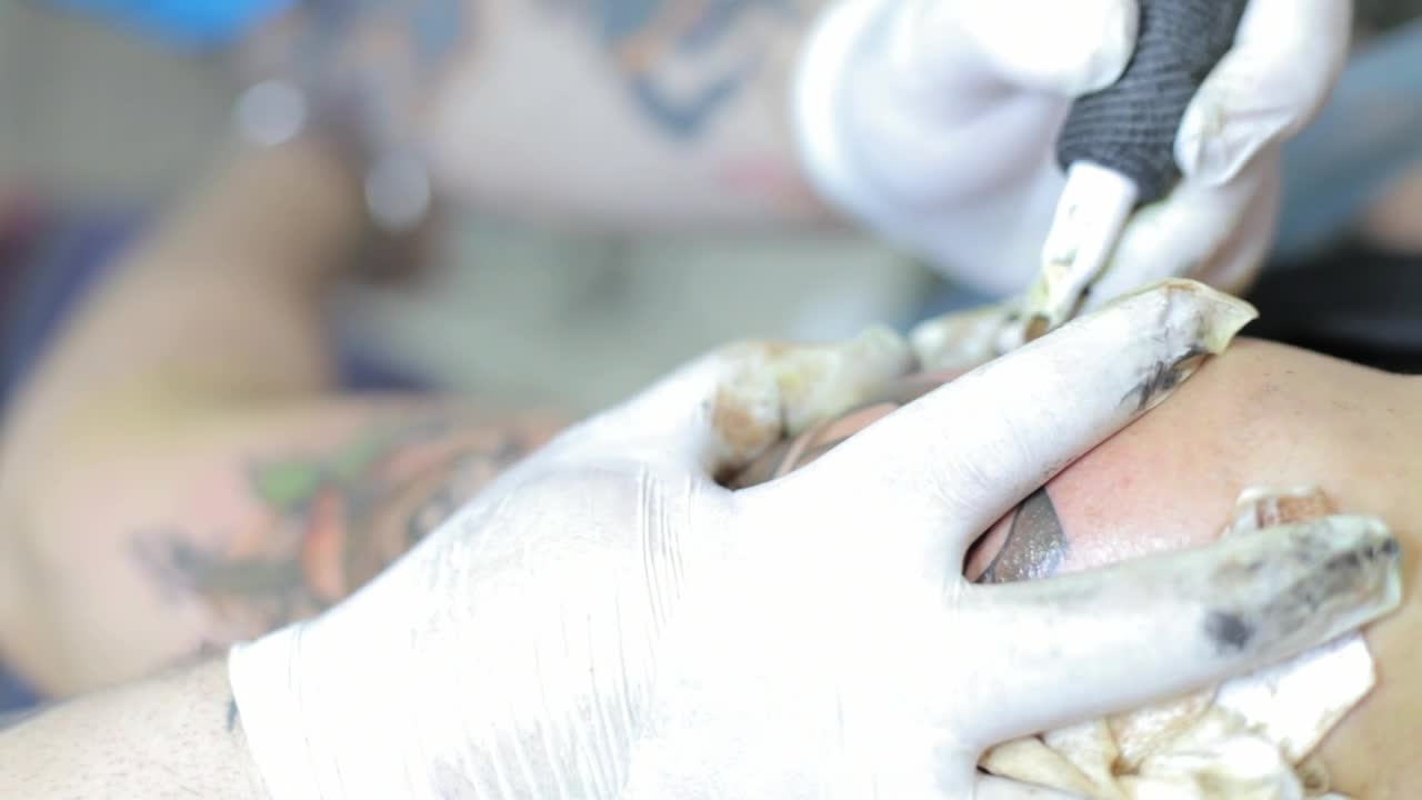 Free Video Stock tattoo artist tattooing a colored flower Live Wallpaper - Free Download
