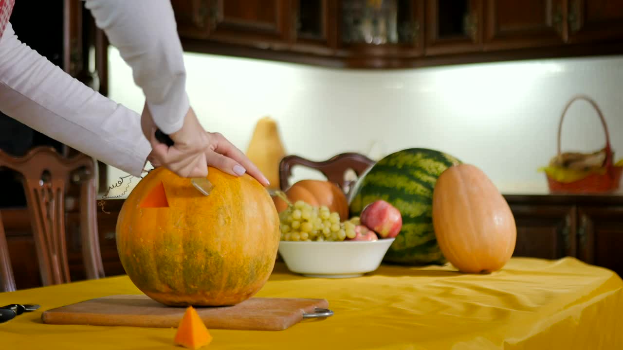 Stock Footage Woman Carves Pumpkin Into Jack O Lantern On Kitchen Table Live Wallpaper - Free Download