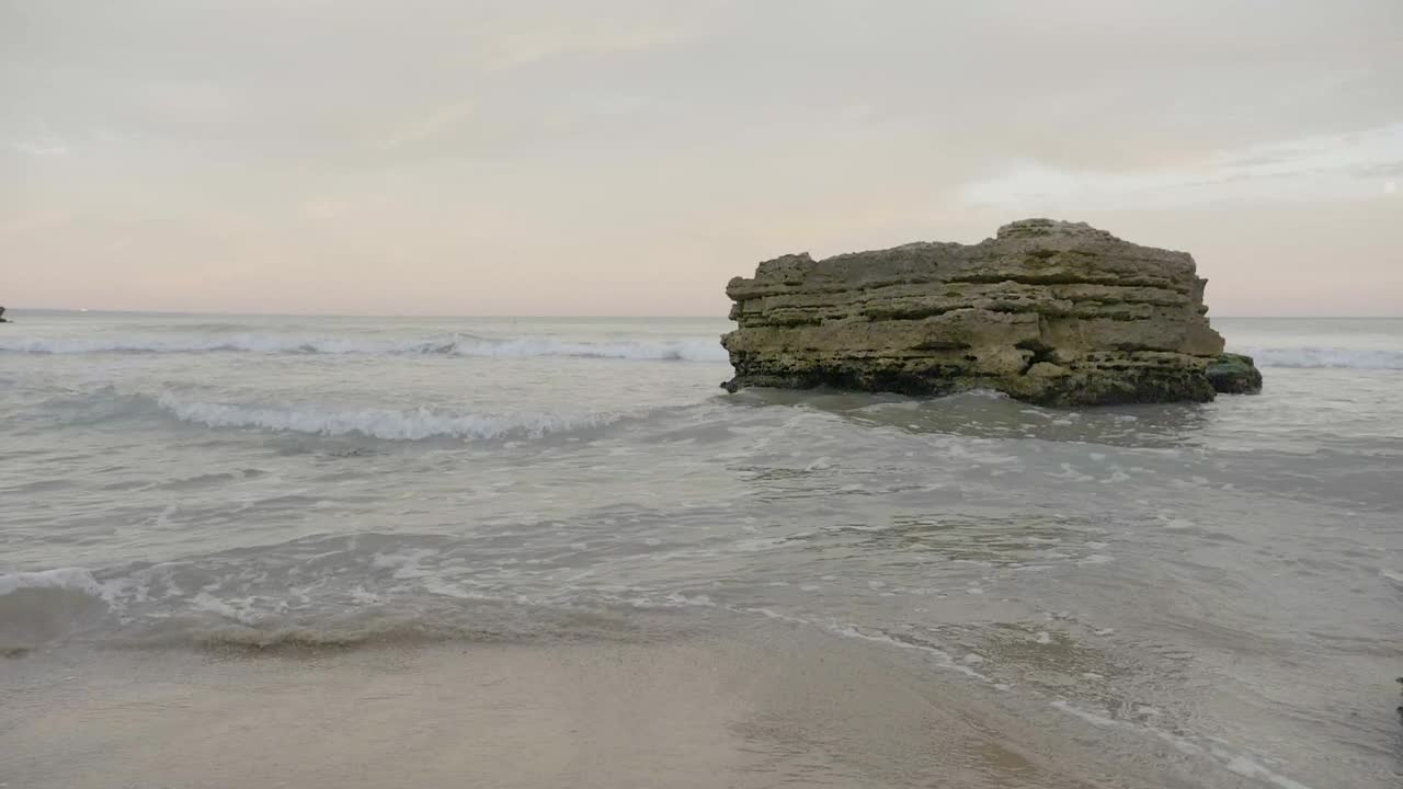 Stock Footage Waves Breaking Against A Large Rock Live Wallpaper - Free Download