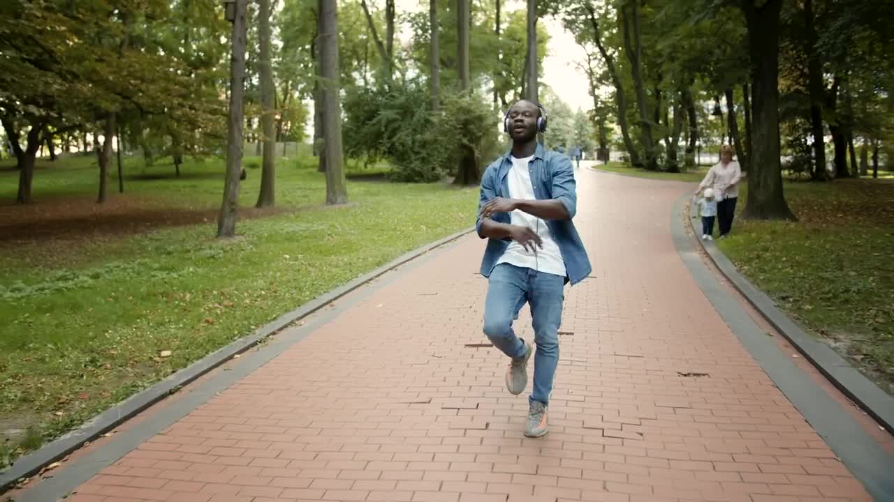 Stock Video Man Dances To Hiphop While Walking In Park Animated Wallpaper - Free Download