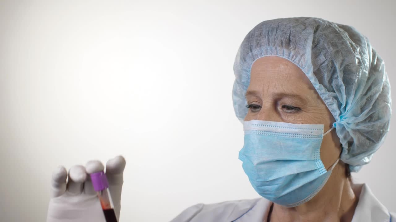 Stock Video Doctor Examining A Blood Test Wearing Mask Live Wallpaper For PC - Free Download