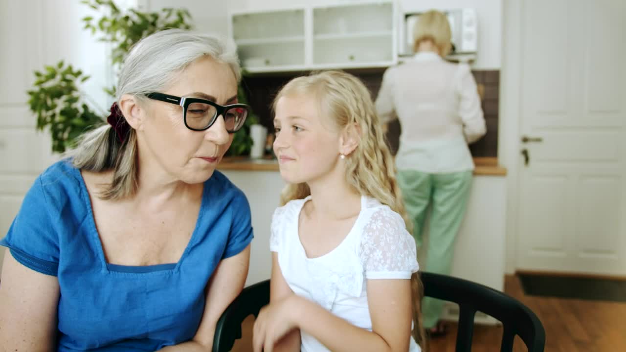 Stock Video Girl Whispers To Grandma While Mom Cooks Live Wallpaper For PC - Free Download