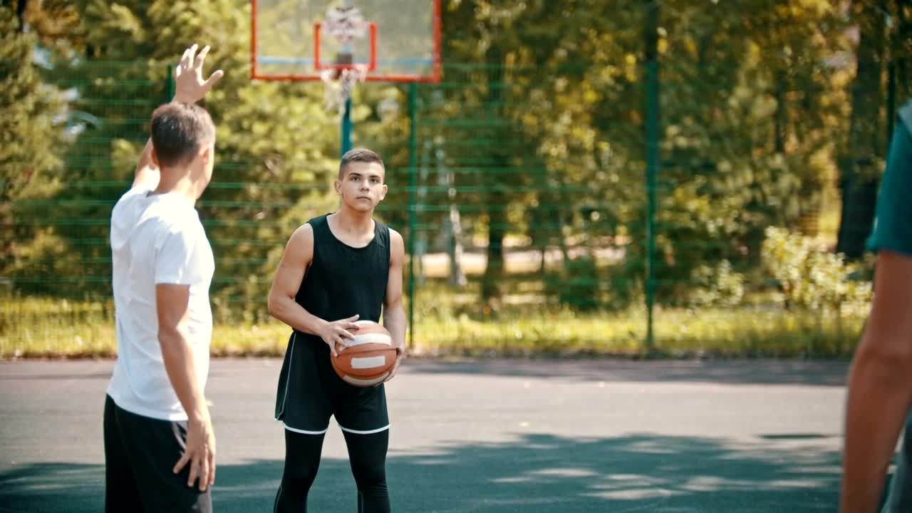 Stock Video Men Playing Basketball On An Outdoor Cour Animated Wallpaper - Free Download