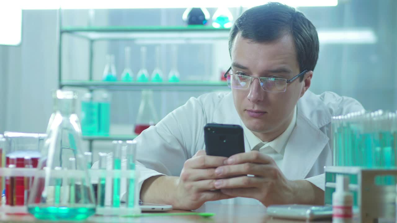 Stock Video Laboratory Scientist Looking At The Phone Animated Wallpaper - Free Download