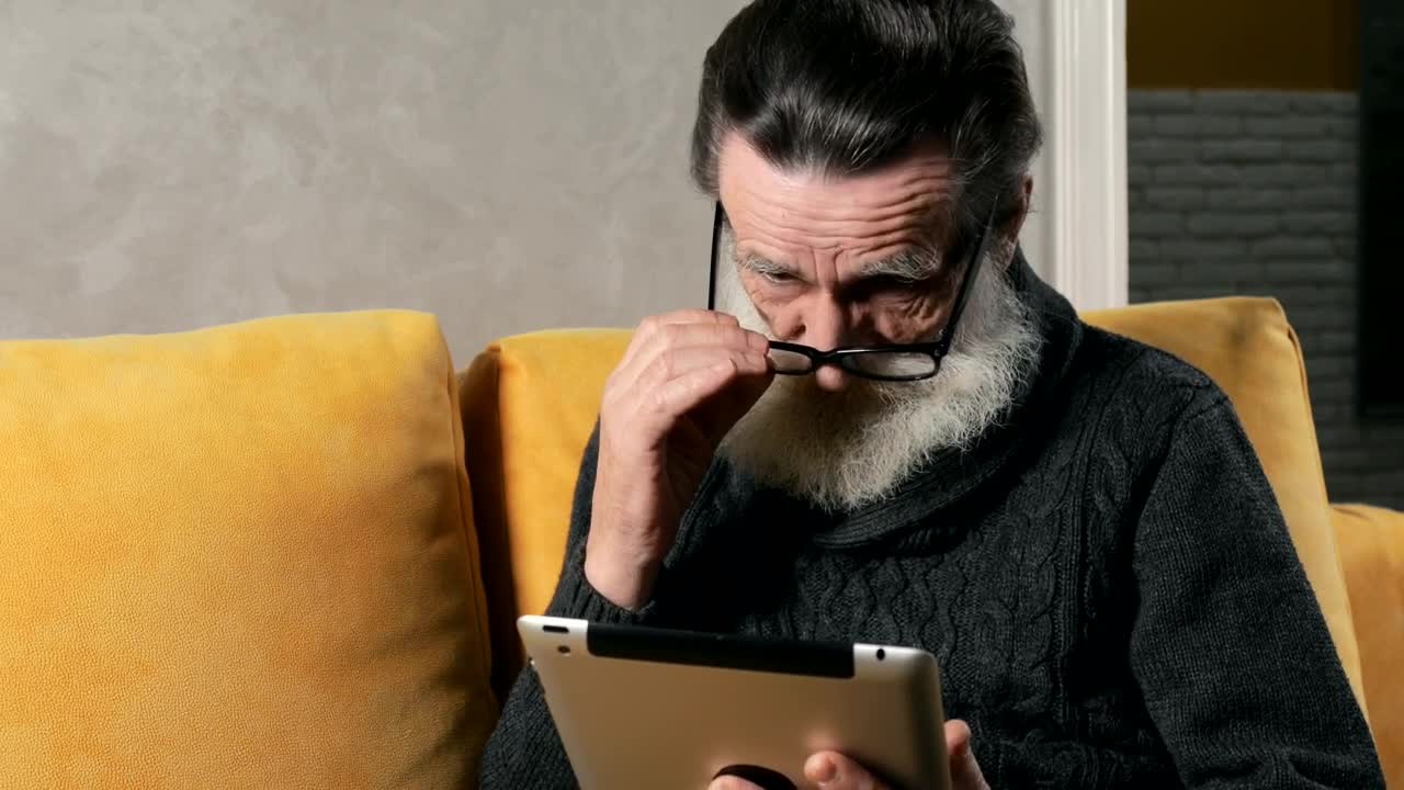 Stock Video Confused Elderly Man Using A Tablet Live Wallpaper For PC - Free Download