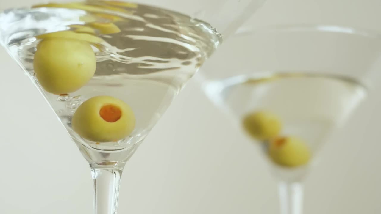 Stock Video Martini Glasses With Olives On A White Backgroun Animated Wallpaper - Free Download