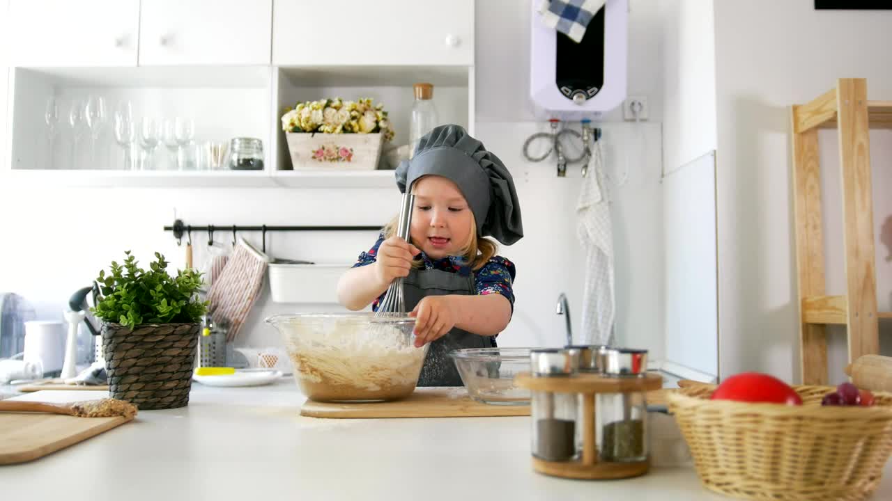 Stock Video Little Girl Making Cookie Mixture In The Kitchen Animated Wallpaper - Free Download