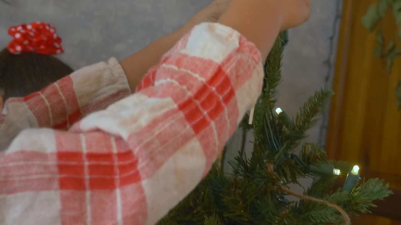 Stock Video Girl Putting The Star Of A Christmas Tree Live Wallpaper For PC - Free Download