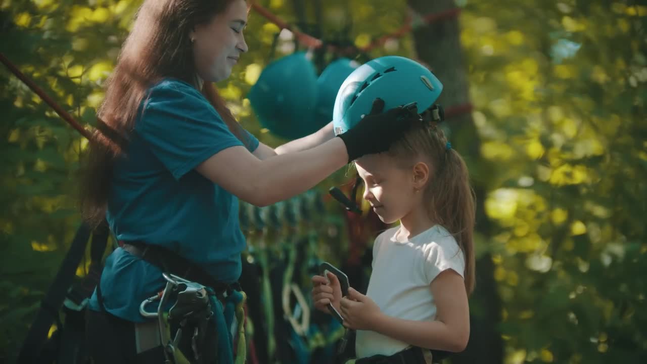 Stock Video Instructor Putting A Protective Helmet On A Little Girl Animated Wallpaper - Free Download