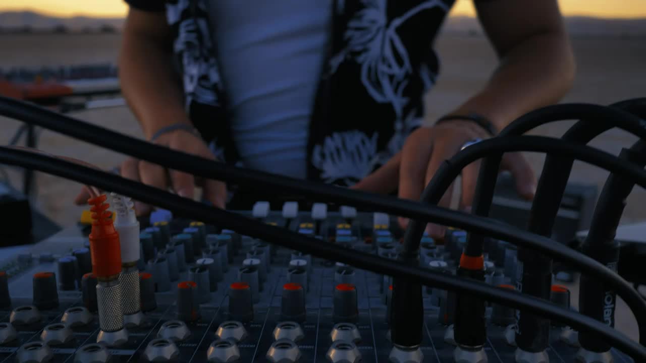 Stock Video Dj Using A Console Mixing In A Desert Live Wallpaper For PC - Free Download