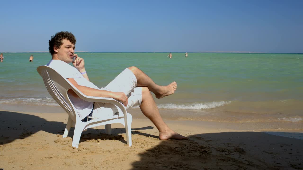 Stock Video Man Calling Home While On Vacation Animated Wallpaper - Free Download