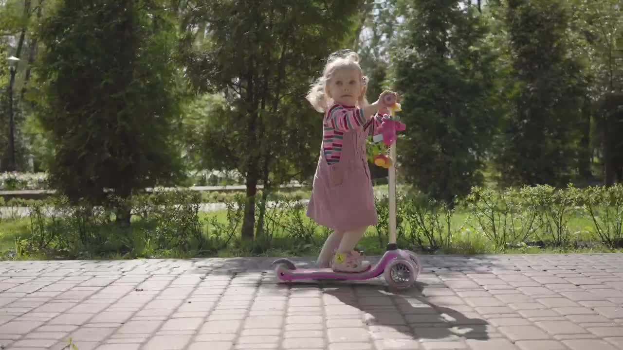 Stock Video Cute Little Girl Rides Scooter Down Brick Sidewalk Live Wallpaper For PC - Free Download