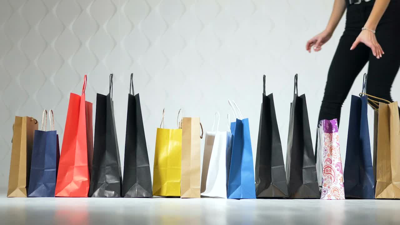 Stock Video Fashionable Women Pick Up Shopping Bags On White Background Live Wallpaper For PC - Free Download