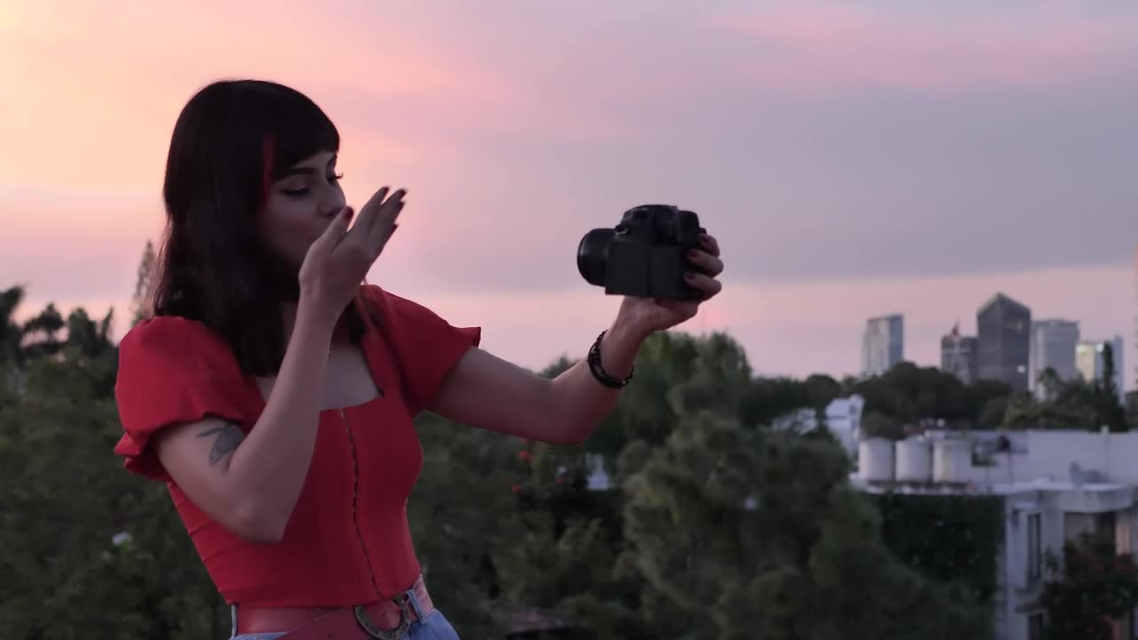 Free Stock Video Woman Shooting A Blog With City Background At The Sunset Live Wallpaper - Free Download