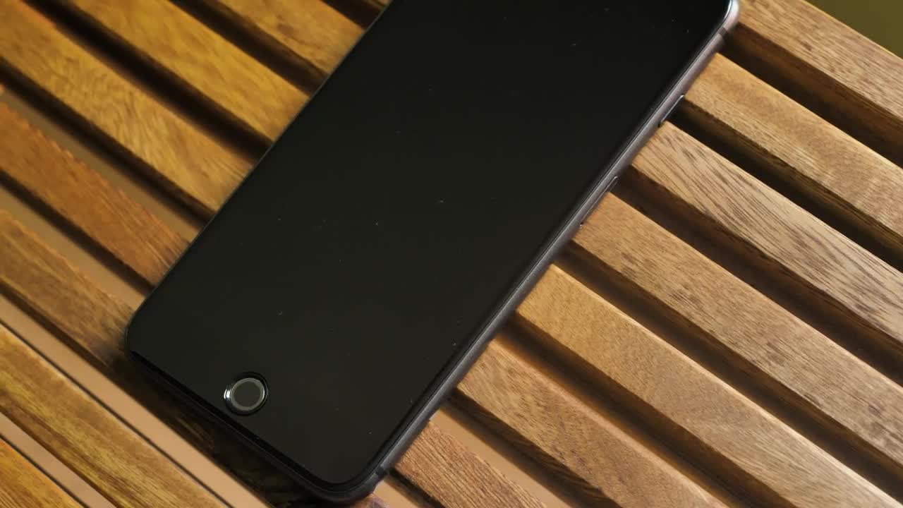 Stock Video Black Cellphone On A Wooden Table Live Wallpaper For PC - Free Download