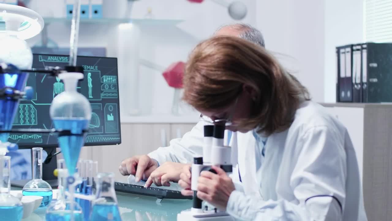 Free Stock Video Research Scientists Collaborate In Modern Lab Live Wallpaper - Free Download