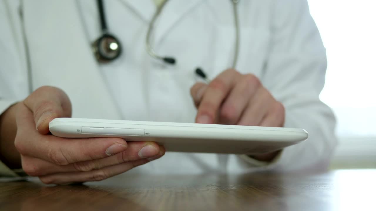 Stock Video Doctor With Gown And Stethoscope Typing On A Tablet Live Wallpaper For PC - Free Download