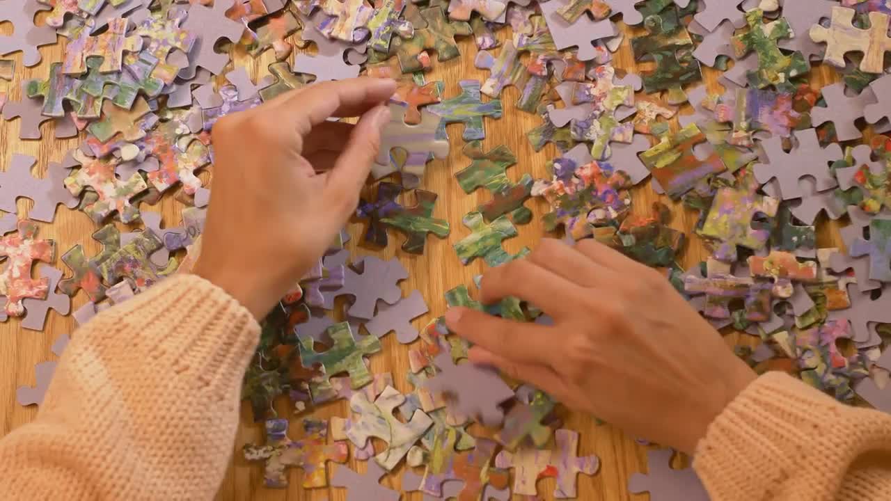 Stock Video Hands Of A Woman Playing With A Puzzle Animated Wallpaper - Free Download