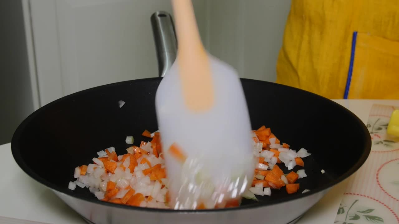 Stock Video Mixing Chopped Vegetables In A Frying Pa Animated Wallpaper - Free Download