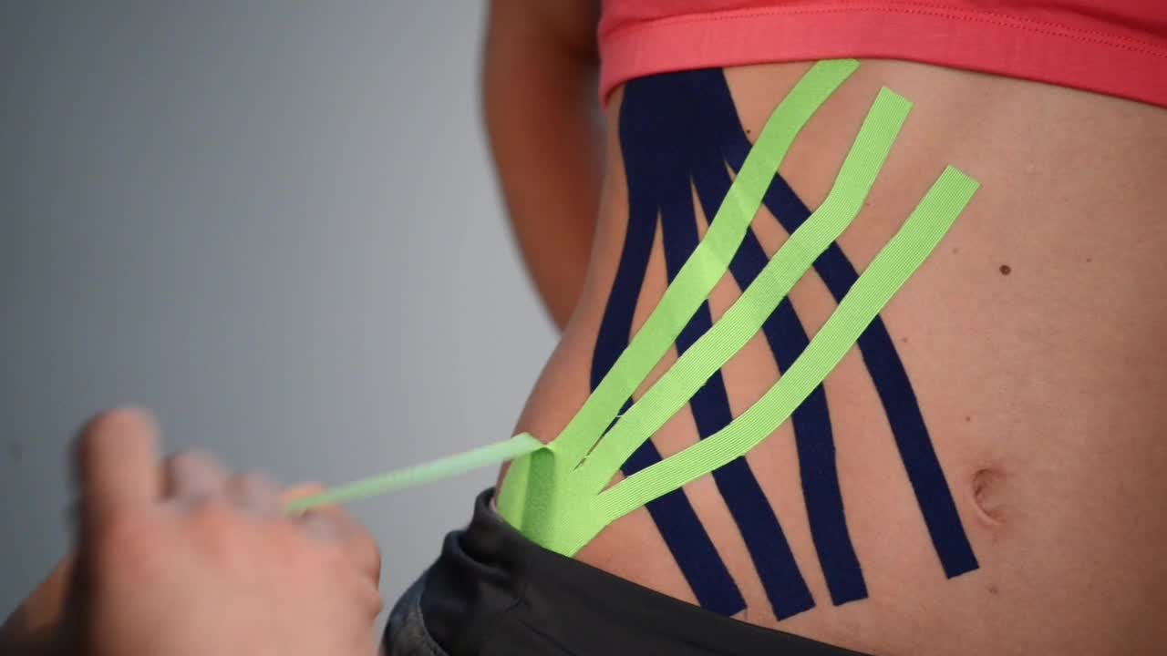 Video Stock Putting Kinesio Tape On An Athletes Hip Live Wallpaper Free - Free Download