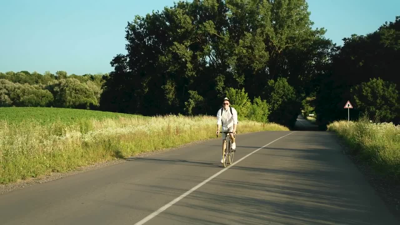 Stock Video Man Enjoys Bicycle Ride In Sunny Countryside Animated Wallpaper - Free Download