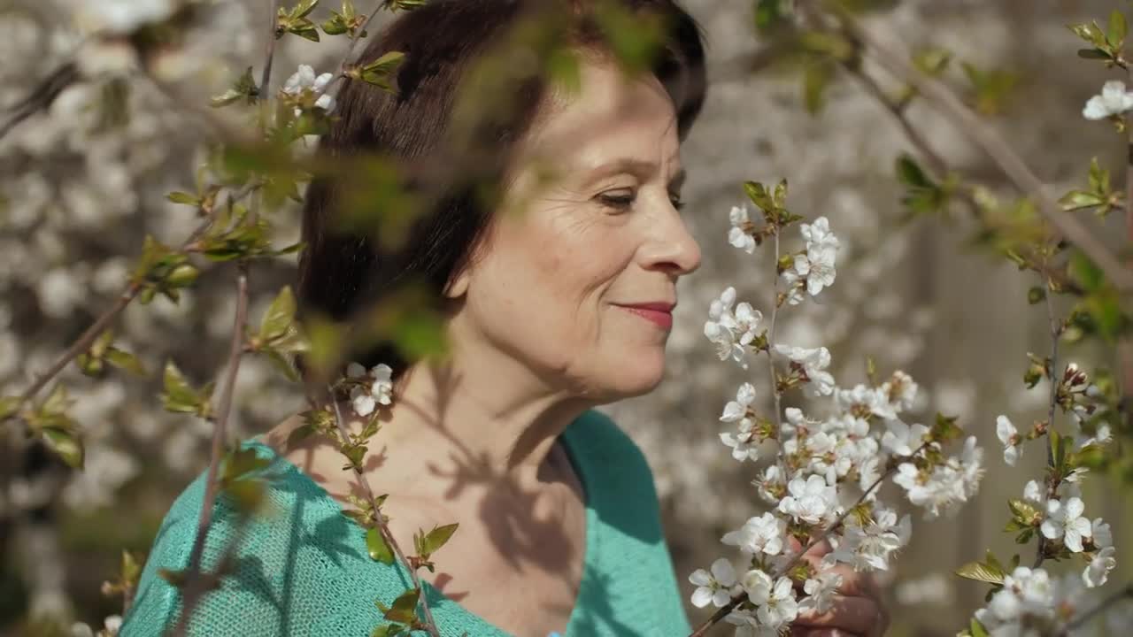 Stock Video Old Woman Smelling Flowers From Her Garden Live Wallpaper - Free Download