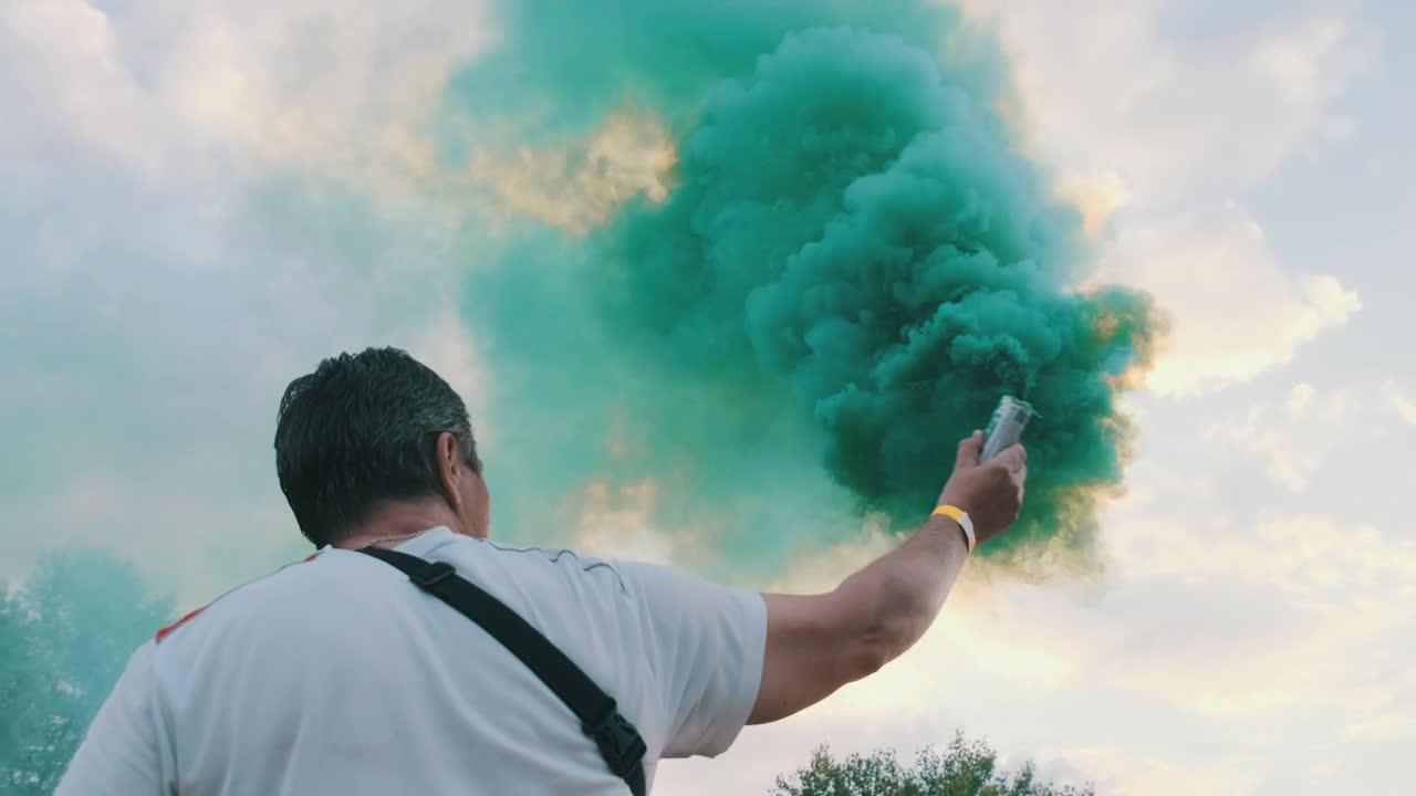 Stock Video Man From Behind Waving A Smoke Bomb Animated Wallpaper - Free Download