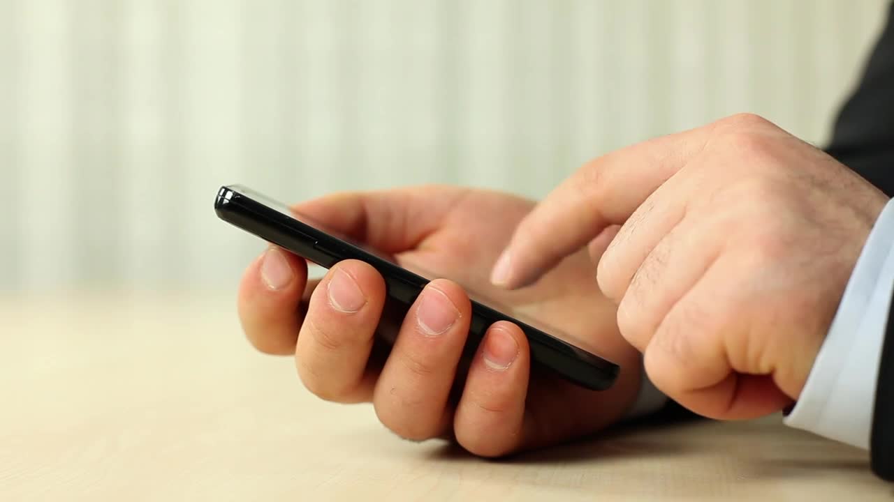 Stock Video Hands Of A Man In A Suit Using His Smartphone Animated Wallpaper - Free Download
