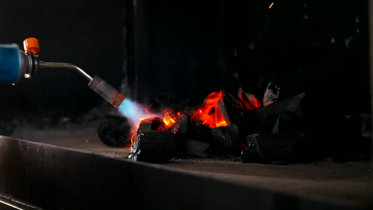 Stock Video Kindling Charcoal For The Grill With A Gas Burner Animated Wallpaper - Free Download